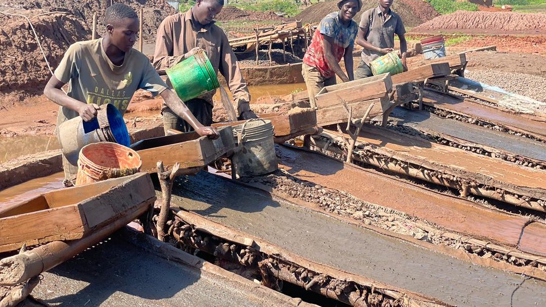 Small-scale miners working sluice boxes
