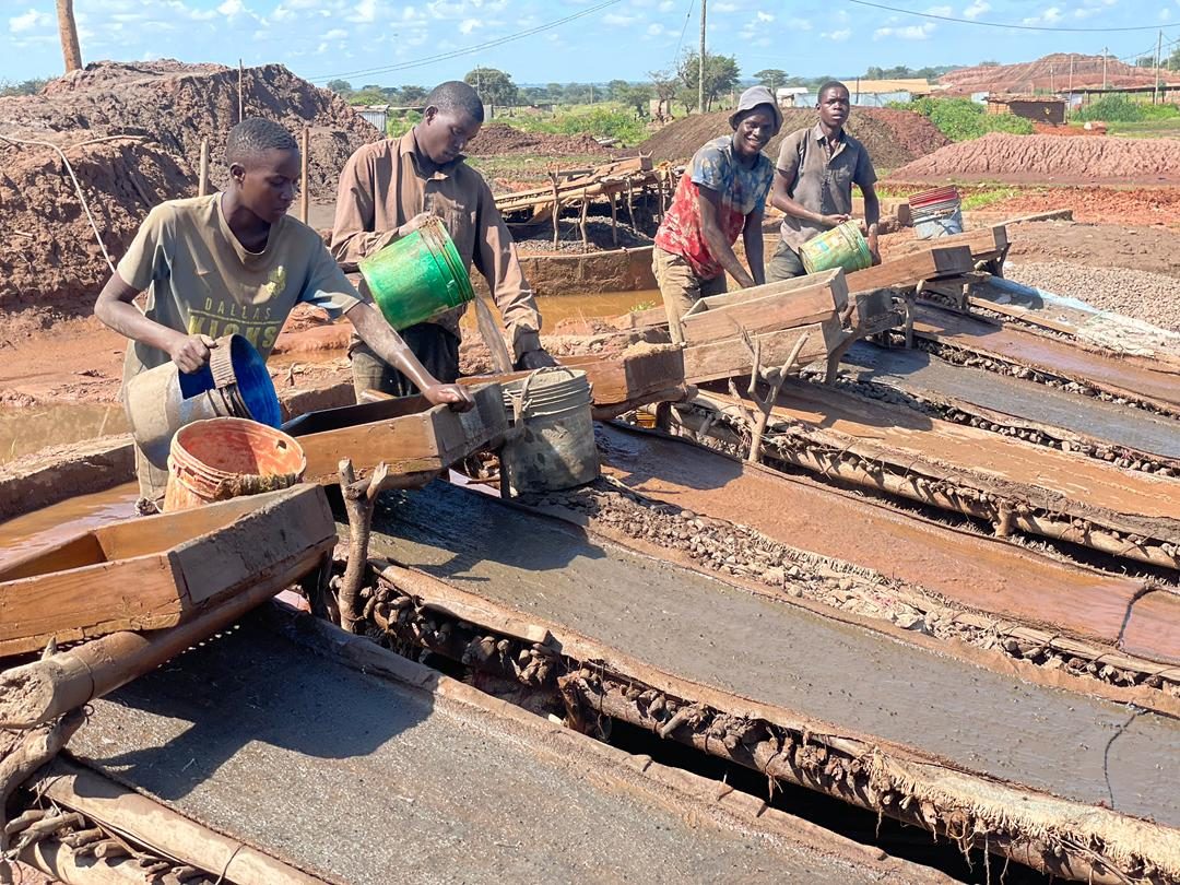 Small-scale miners working sluice boxes